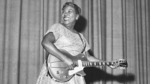 Sister Rosetta Tharpe onstage with her guitar in 1957.
